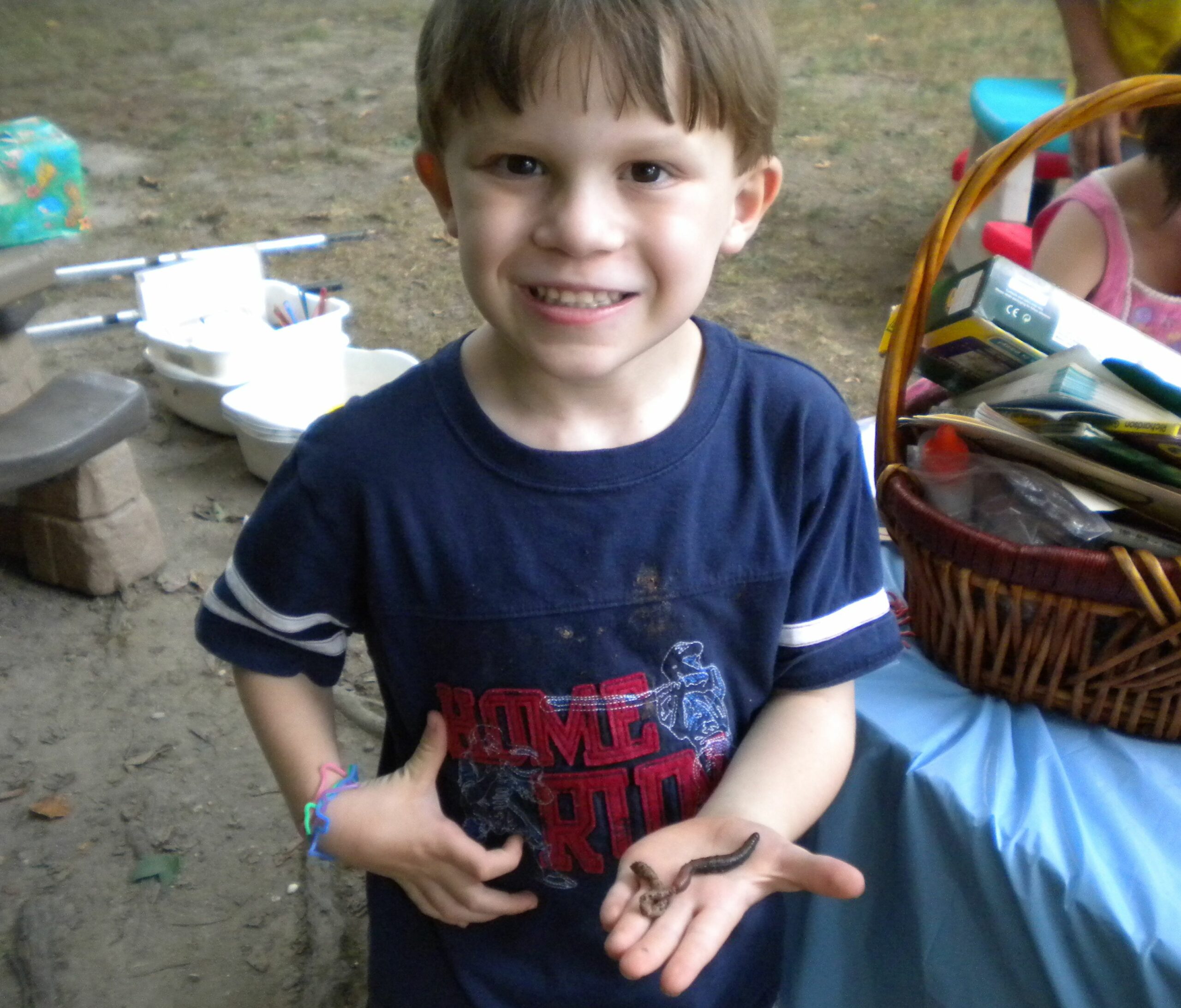 Sheldrake happy birthday boy holding worm at birthday party