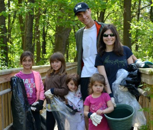 Sheldrake family volunteering for cleanup with trash bags, gloves