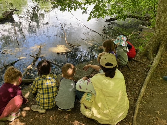 Sheldrake Naturalist sitting at pond with children