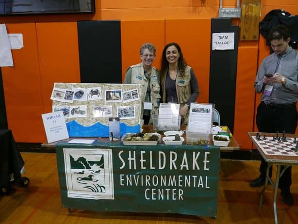 Sheldrake naturalists wearing nature vests at Sheldrake display table