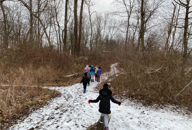 Kids running down Sheldrake path in the snow.