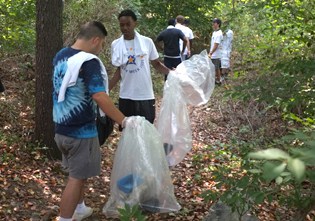 group of young men cleaning up trash at Sheldrake